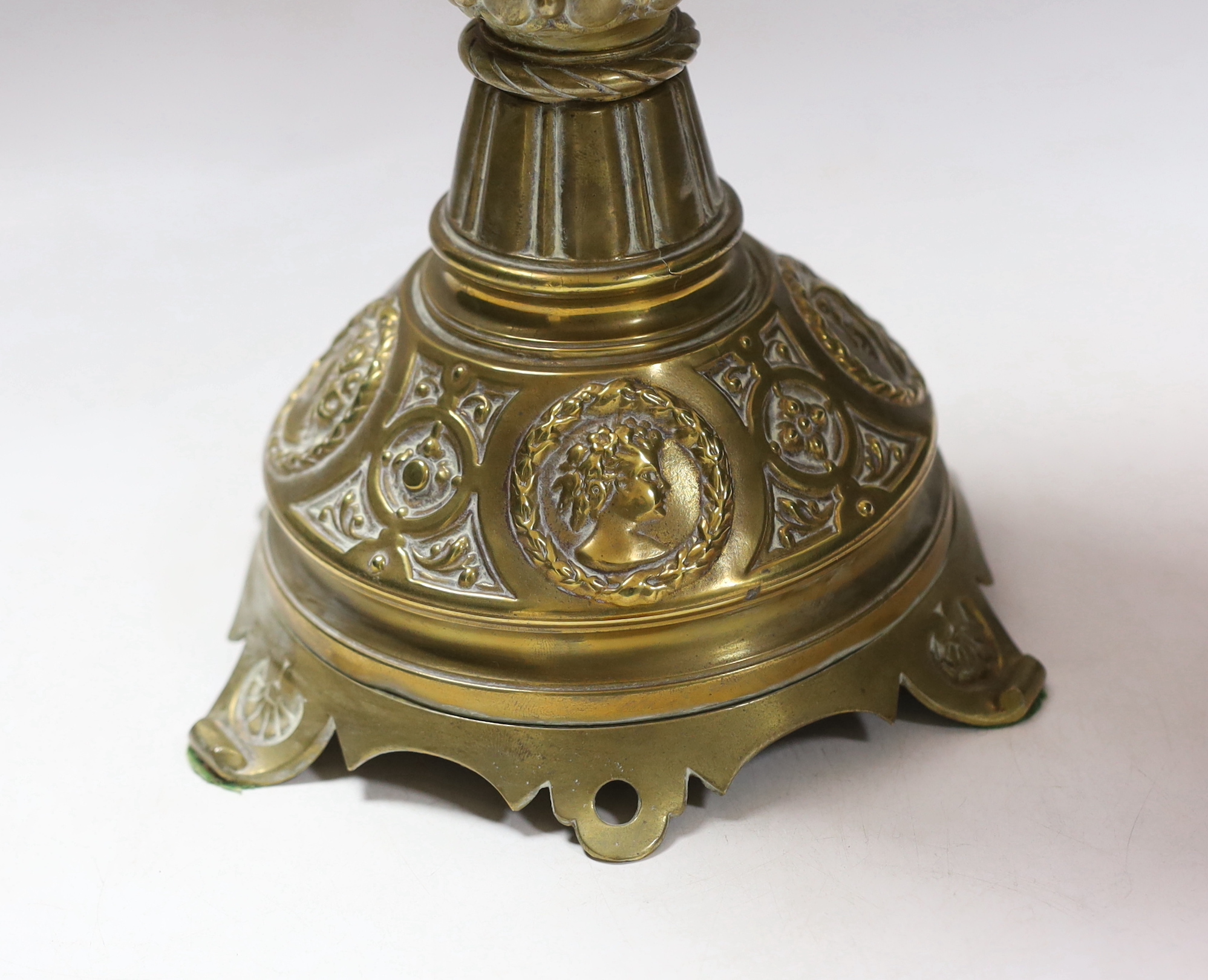 A Victorian brass based oil lamp, with cranberry glass shade, 58cm high